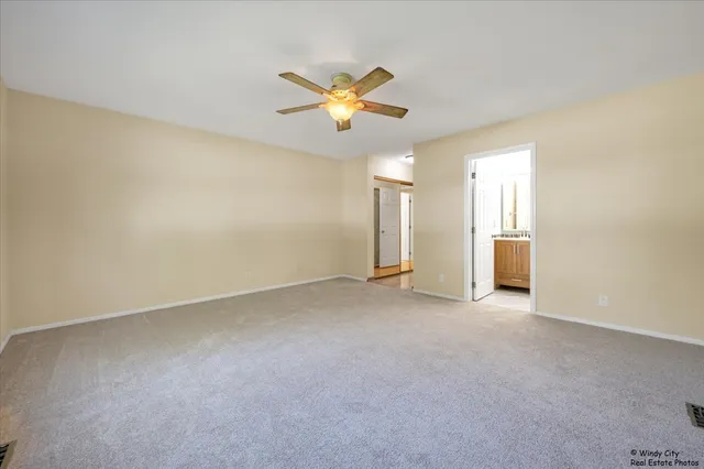 a view of a livingroom with a ceiling fan and window