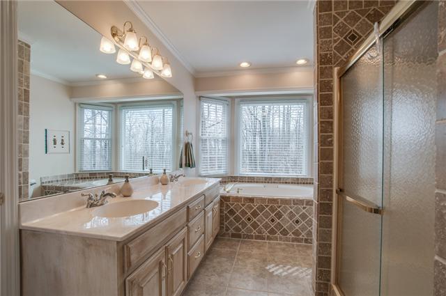 8694 Haselton Road Nashville, TN 37221 - Photo 11 of 19 Master bath with double sinks, large soaking tub, tile shower, linen closet, recessed lighting, crown molding and tile floor.