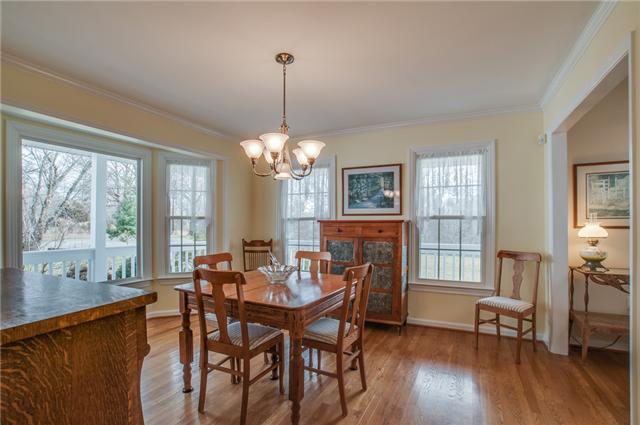 8694 Haselton Road Nashville, TN 37221 - Photo 4 of 19 Formal dining room with bay window, crown molding, chandelier and hardwood floors.