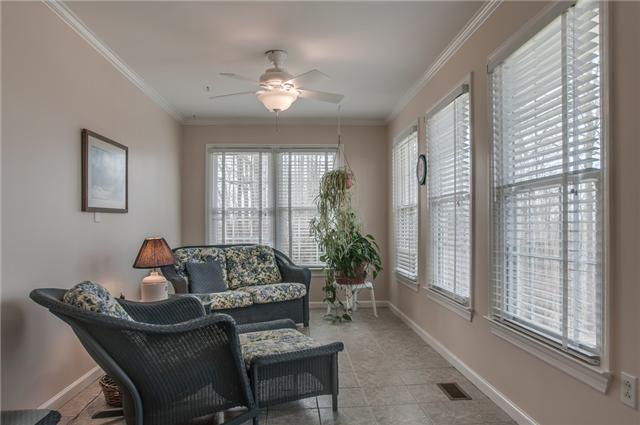8694 Haselton Road Nashville, TN 37221 - Photo 6 of 19 Bright and airy sun room with crown molding, ceiling fan and tile floor.
