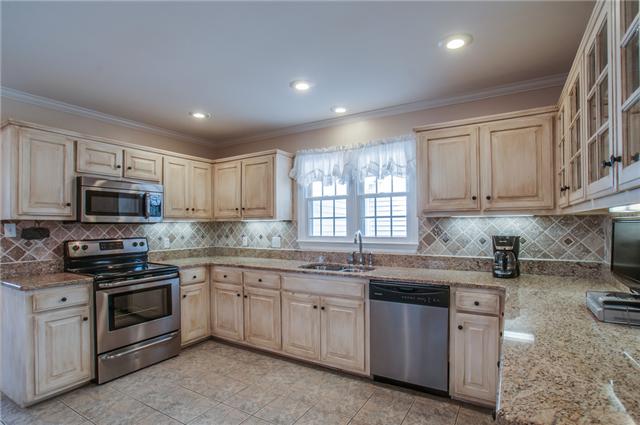 8694 Haselton Road Nashville, TN 37221 - Photo 7 of 19 Kitchen with new granite, lots of cabinets, under cabinet lighting, tile backsplash, built in desk area, recessed lighting, tile floor and all new Frigidaire Stainless Appliances including side by side refrigerator.