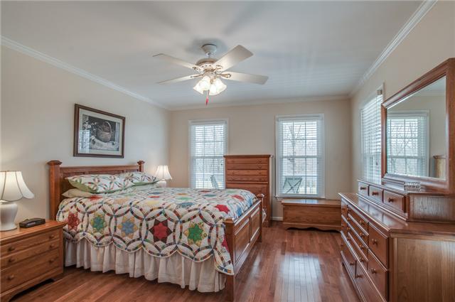 8694 Haselton Road Nashville, TN 37221 - Photo 10 of 19 First floor master suite with ceiling fan, crown molding, large walk in closet and hardwood floors.