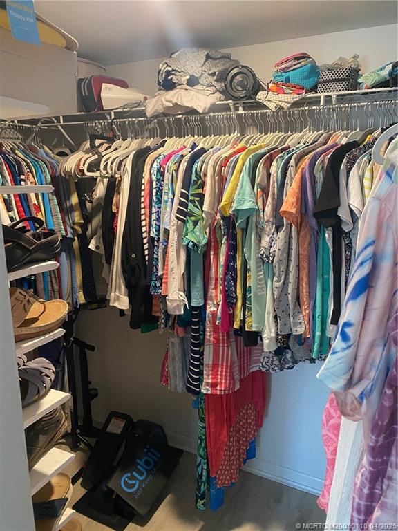 3121 Southeast Aster Lane, Unit 1601 Stuart, FL 34994 - Photo 52 of 58 a view of walk in closet with clothes and shoes