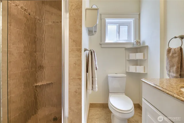 a white toilet sitting next to a bathroom sink
