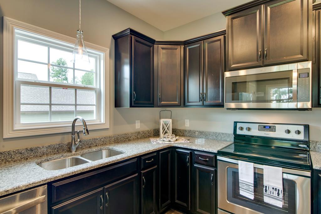 417 Kaiser Road Dickson, TN 37055 - Photo 11 of 30 a kitchen with stainless steel appliances granite countertop a sink stove and microwave