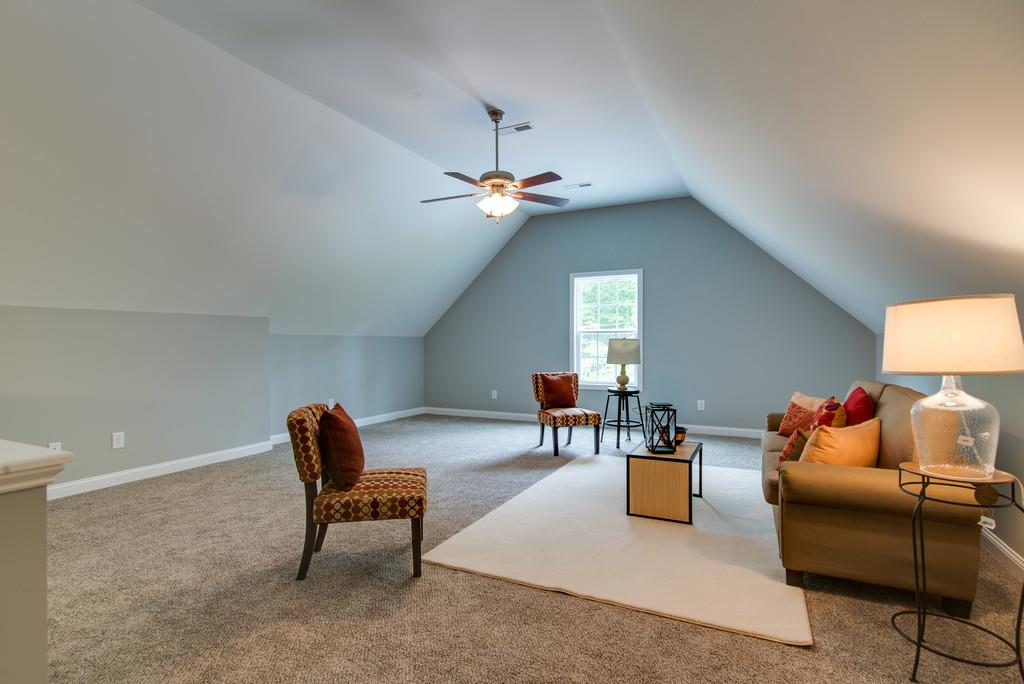 417 Kaiser Road Dickson, TN 37055 - Photo 27 of 30 a living room with furniture and a chandelier