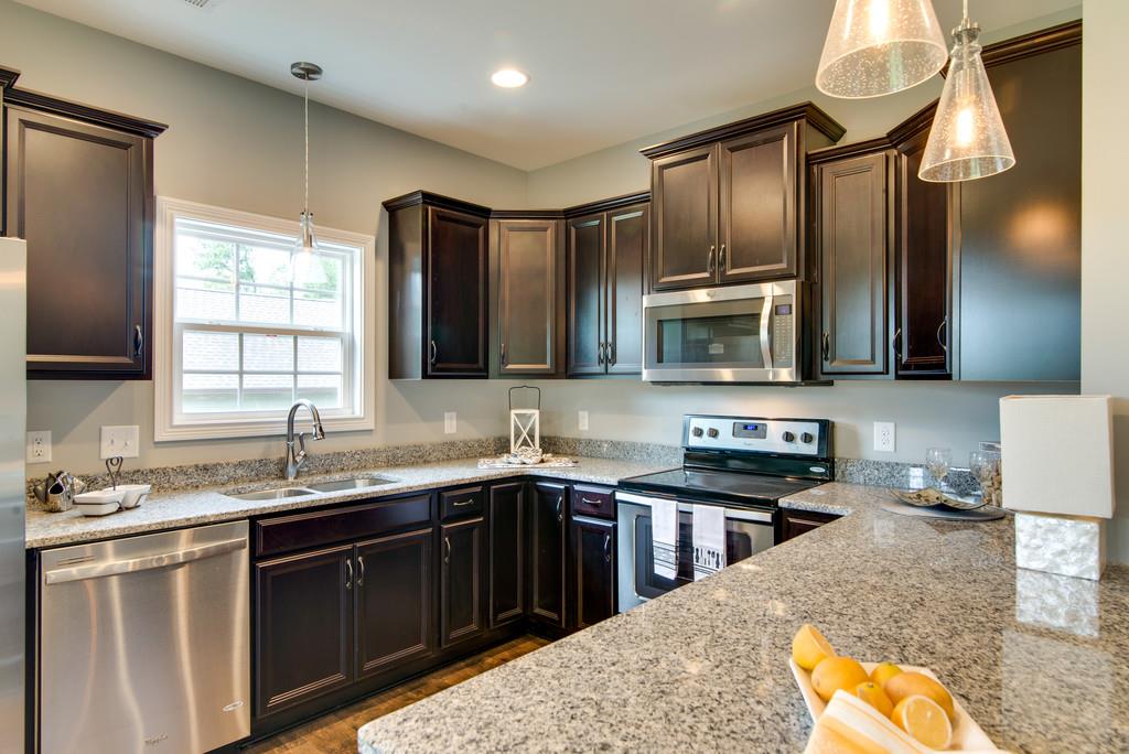 417 Kaiser Road Dickson, TN 37055 - Photo 8 of 30 a kitchen with stainless steel appliances granite countertop a sink stove and oven
