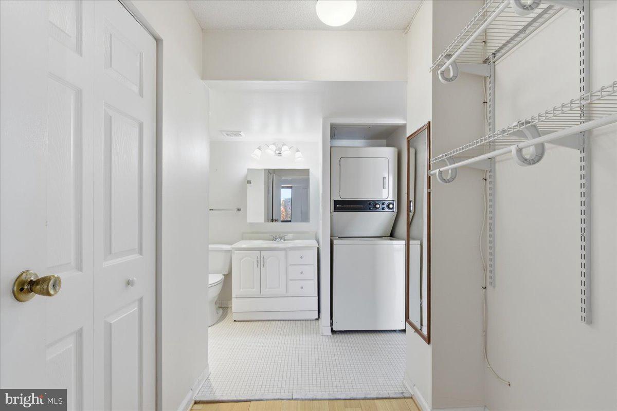 1401 North Rhodes Street, Unit 503 Arlington, VA 22209 - Photo 14 of 17 a kitchen with white cabinets and refrigerator