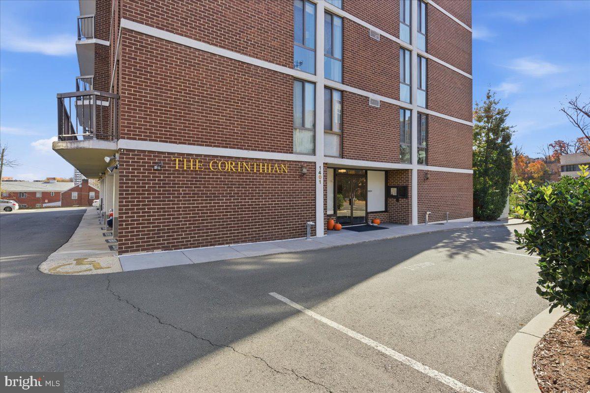 1401 North Rhodes Street, Unit 503 Arlington, VA 22209 - Photo 21 of 25 a view of a building with car parked on road