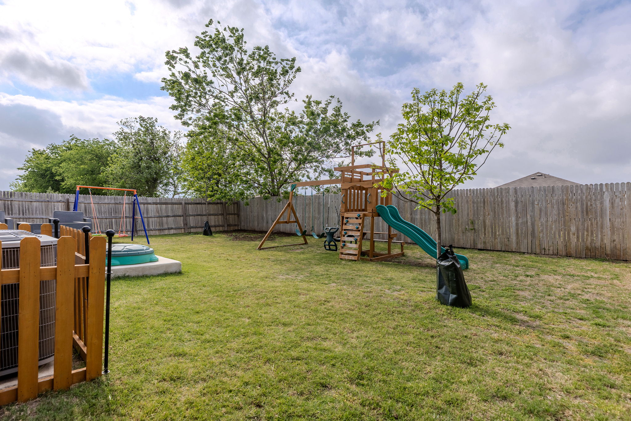 404 Cassandra Drive Hutto, TX 78634 - Photo 39 of 40 Fenced backyard featuring a swimming pool and a playground