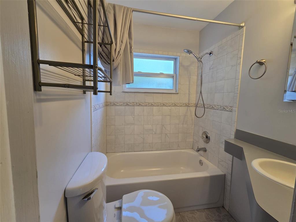 7216 James Street Port Richey, FL 34668 - Photo 17 of 28 a bathroom with a tub a toilet and a shower