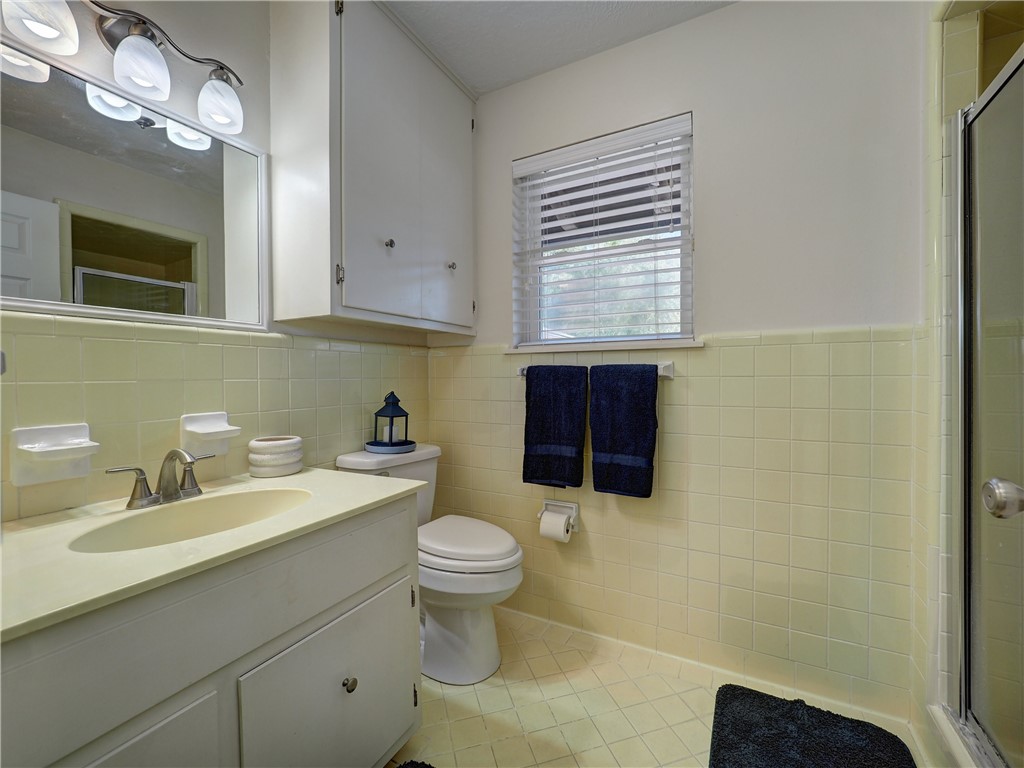 161 Sunset Ingleside, TX 78362 - Photo 18 of 35 a bathroom with a sink toilet a mirror and shower curtain