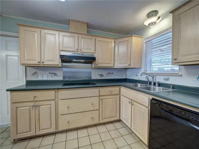 a kitchen with stainless steel appliances kitchen island granite countertop a refrigerator and a sink
