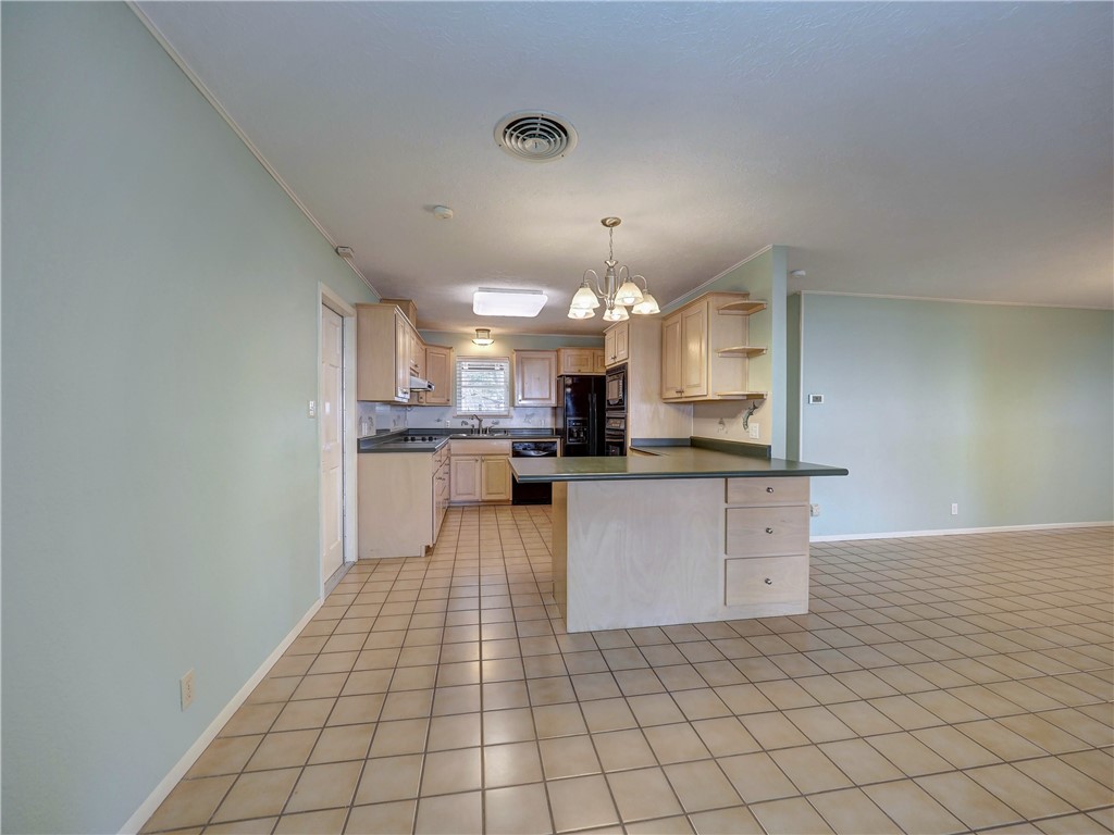 161 Sunset Ingleside, TX 78362 - Photo 7 of 35 a kitchen with stainless steel appliances kitchen island granite countertop a refrigerator and a sink