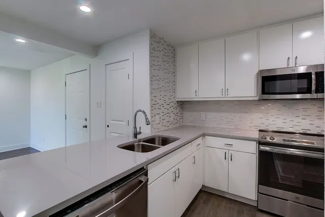 a stove top oven sitting inside of a kitchen