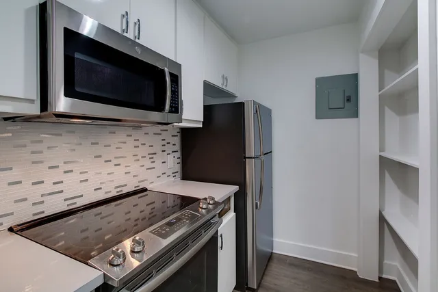 a stove top oven sitting inside of a kitchen