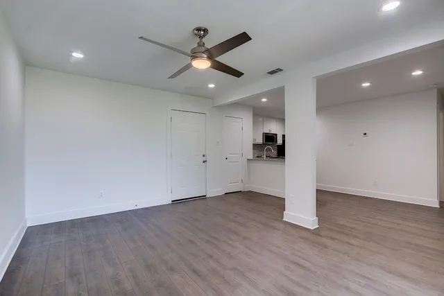 a kitchen with a refrigerator and a stove top oven