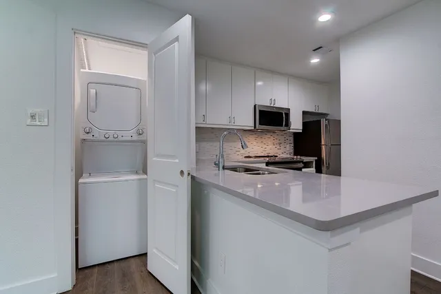 a kitchen with a sink and cabinets