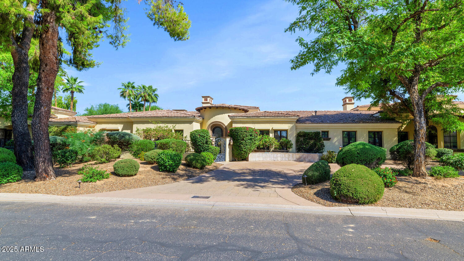front view of a house with a yard and potted plants