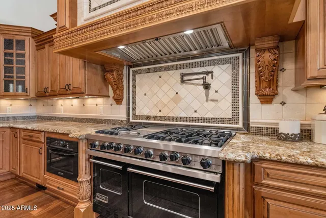 a stove top oven sitting inside of a kitchen