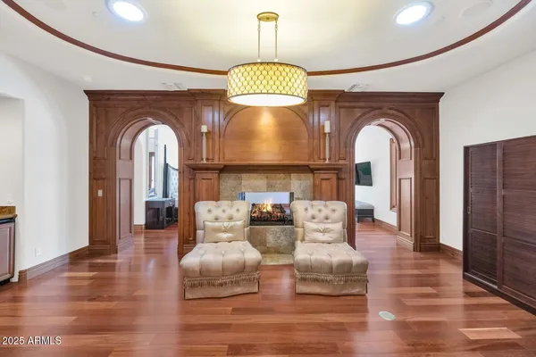 a living room with furniture and chandelier
