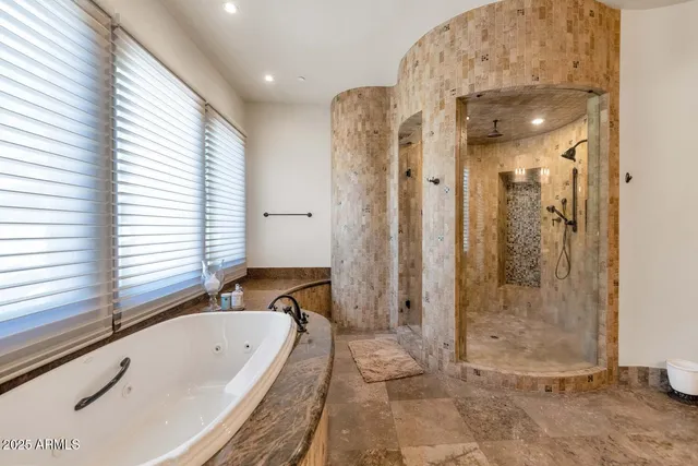 a bathroom with a tub a sink and a shower