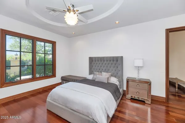 a bedroom with a bed and a large window