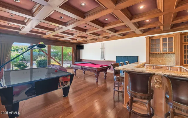 a dining room with wooden floor a table and chairs