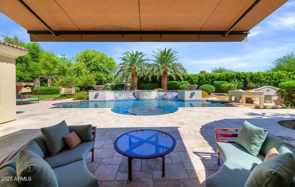 a swimming pool with outdoor seating and yard