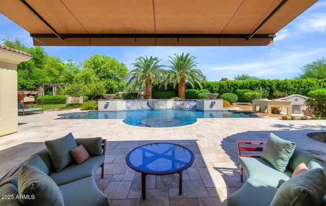 a swimming pool with outdoor seating and yard