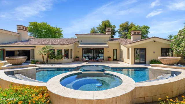a view of a house with swimming pool and furniture
