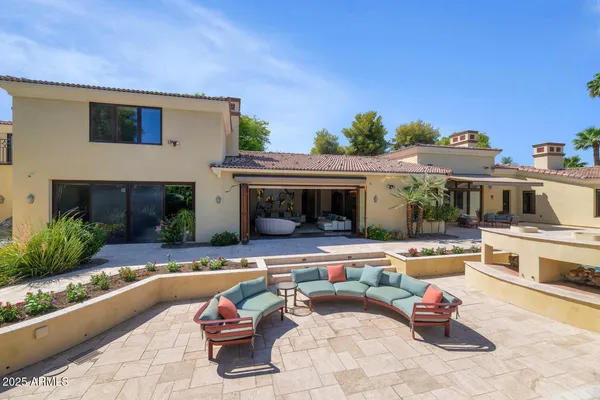 a view of a house with swimming pool and sitting area