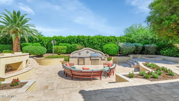 a view of a chairs and table in backyard