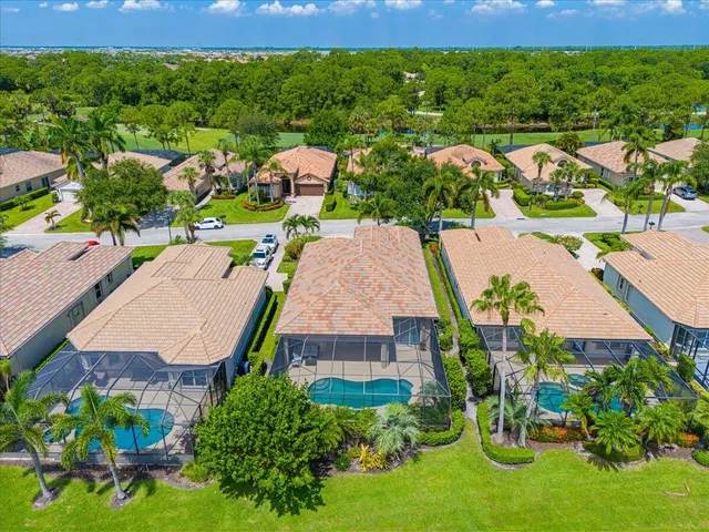 an aerial view of residential houses with outdoor space and street view