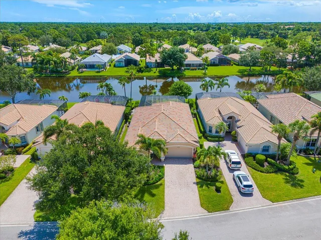an aerial view of a house with swimming pool and garden