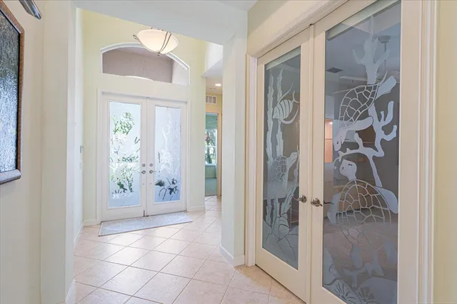 a view of a hallway with wooden floor and chandelier
