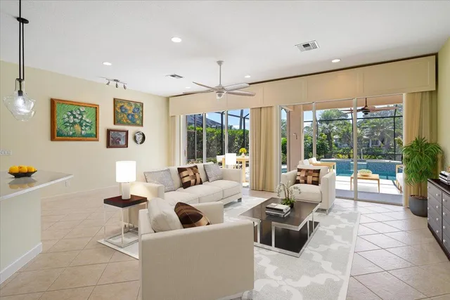 a view of empty room with floor to ceiling window and ceiling fan