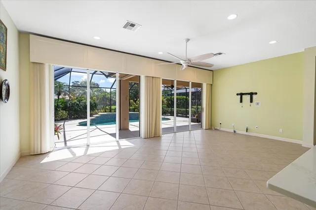 a view of a kitchen with refrigerator and chairs