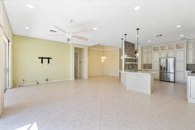 a kitchen with stainless steel appliances granite countertop a refrigerator and a stove top oven
