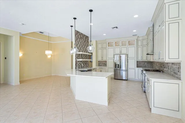 a kitchen with stainless steel appliances granite countertop a stove and a sink