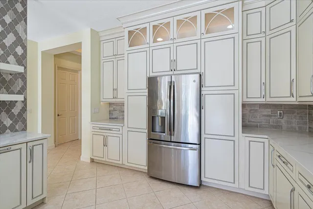 a kitchen with a sink a counter top space and a chandelier