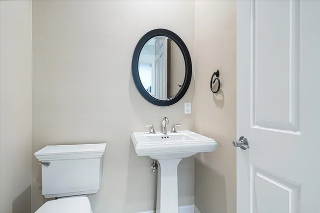 a spacious bedroom with a large bed and a chandelier