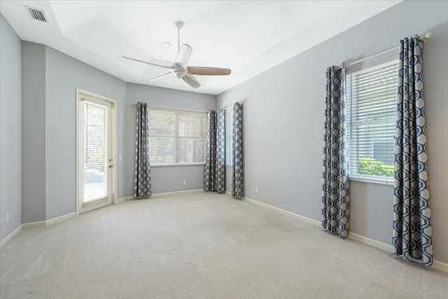 a bathroom with a granite countertop sink a mirror and shower