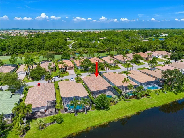 an aerial view of residential houses with outdoor space and river