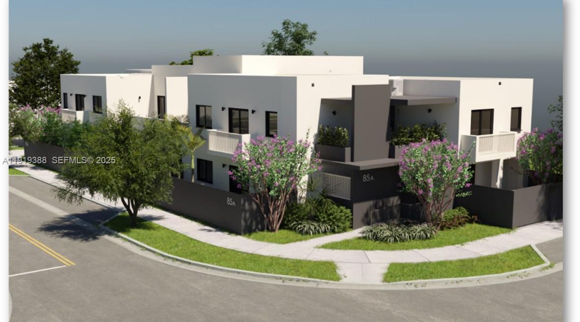 85 Northeast 55th Street, Unit 4 Miami, FL 33137 - Photo 3 of 15 a front view of a house with a yard and garage