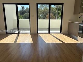 85 Northeast 55th Street, Unit 4 Miami, FL 33137 - Photo 9 of 15 an empty room with wooden floor and windows