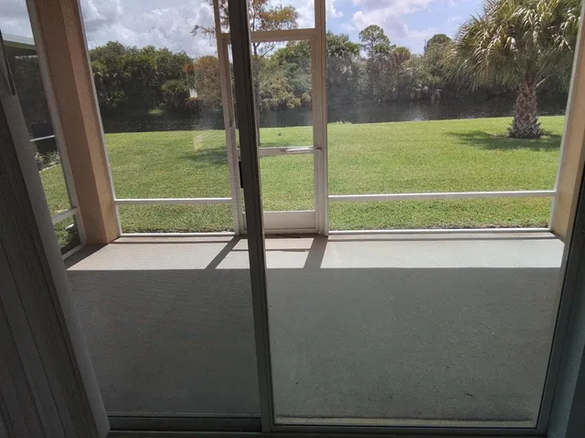 a view of a room with a big yard