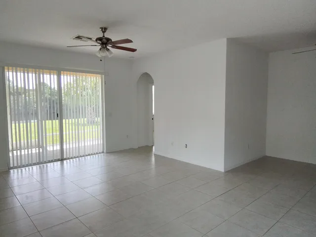 a view of a livingroom with a ceiling fan and window