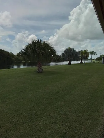 a view of outdoor space with green field and trees