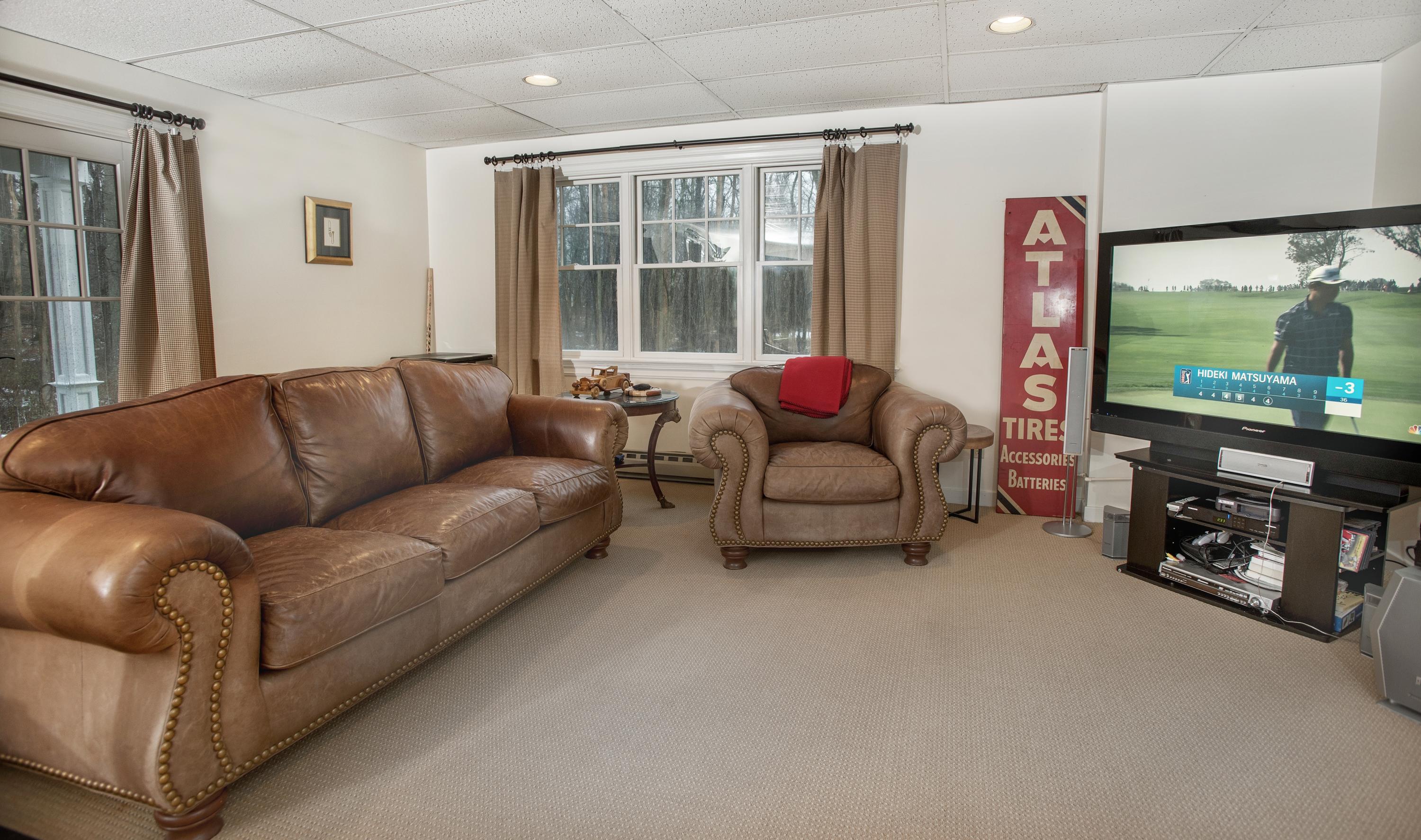 130 Skyview Lane New Canaan, CT 06840 - Photo 40 of 44 a living room with furniture and a flat screen tv